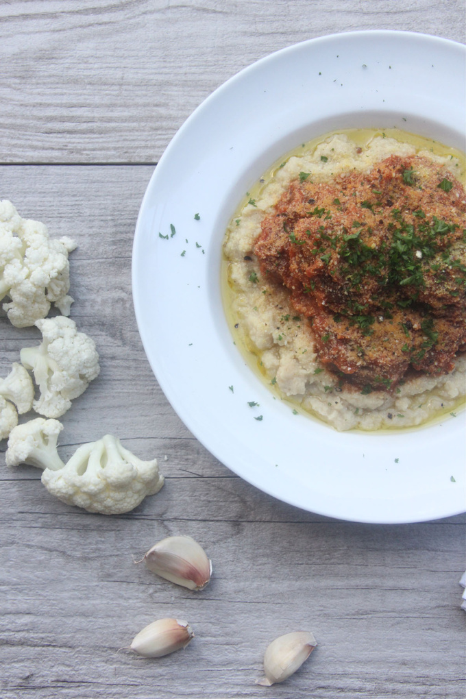 Top down of italian meatballs with cauliflower mash on white plate