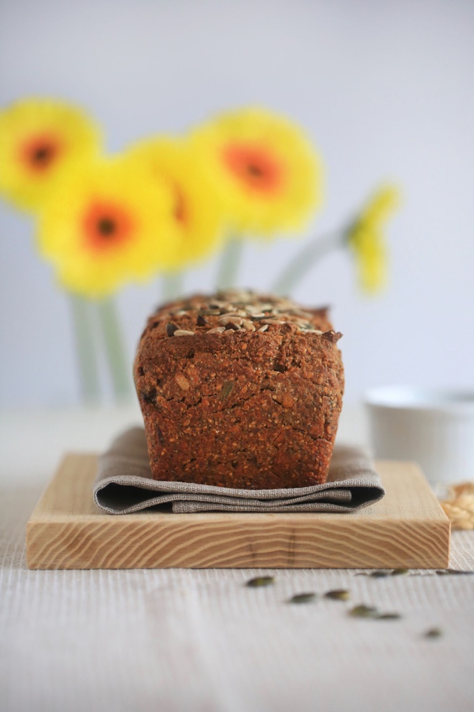 easy and delicious five seed sourdough bread with sunflowers in background