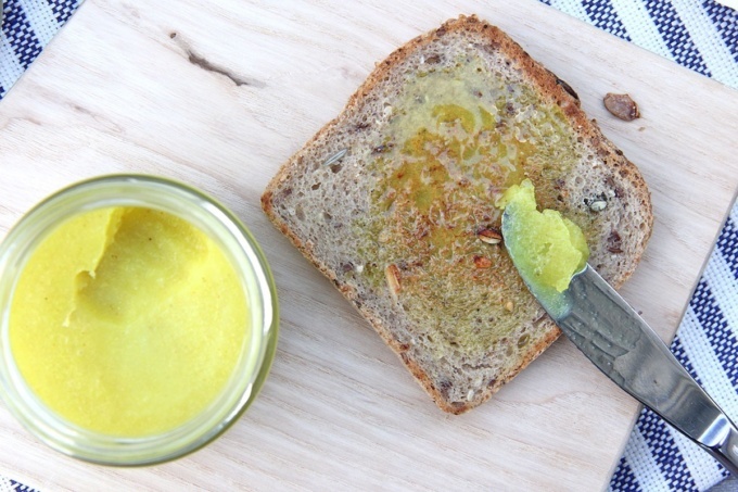 turmeric butter on sourdough toast with sliver knife and wooden board 