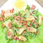 Delicious seasonal feijoa recipe, a savoury way to use feijoas in a salad, with caramelised walnuts, brown rice, caramelised red onions, grounding brown rice, and a sweet balsamic dressing.
