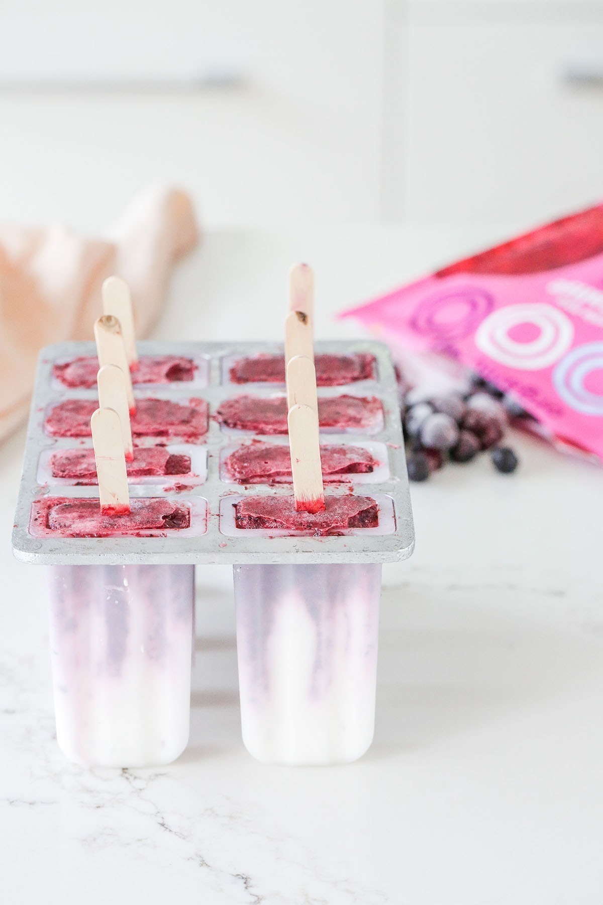 Fresh berries and dairy free coconut yoghurt, blended into an easy 5 minute, 5 ingredient ice cream popsicle. Good for the kids, and adults too! Healthy, easy, and super low in sugar.