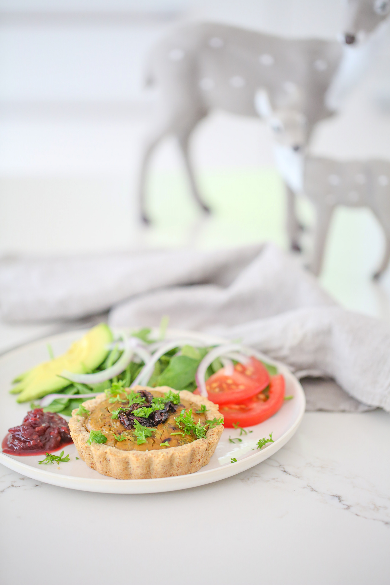 Healthy savoury vegan mini quiche with relish, parsley, salad, red onion, tomato, avocado