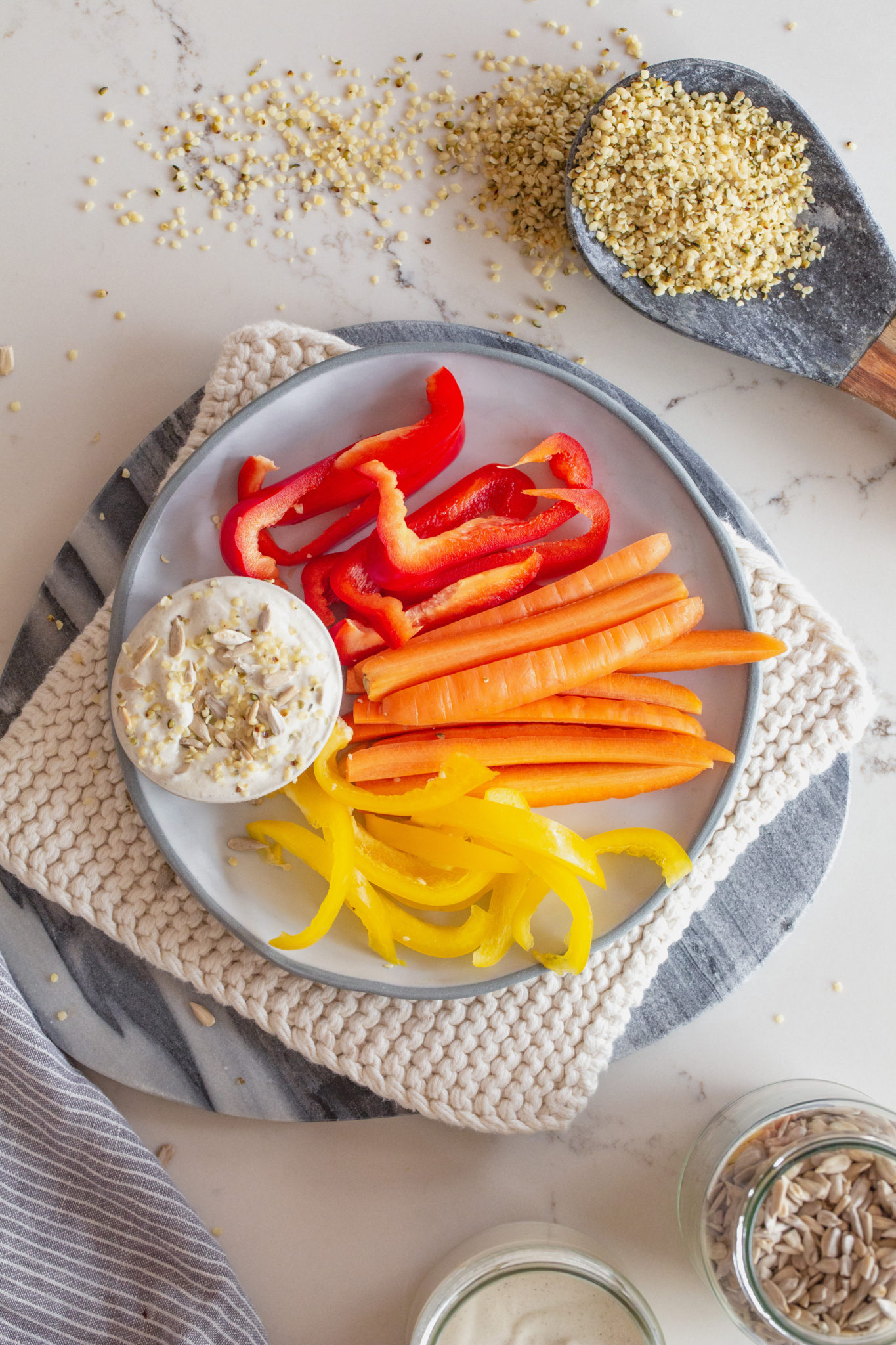 Hemp and sunflower aioli with fresh capsicum and carrot on a plate