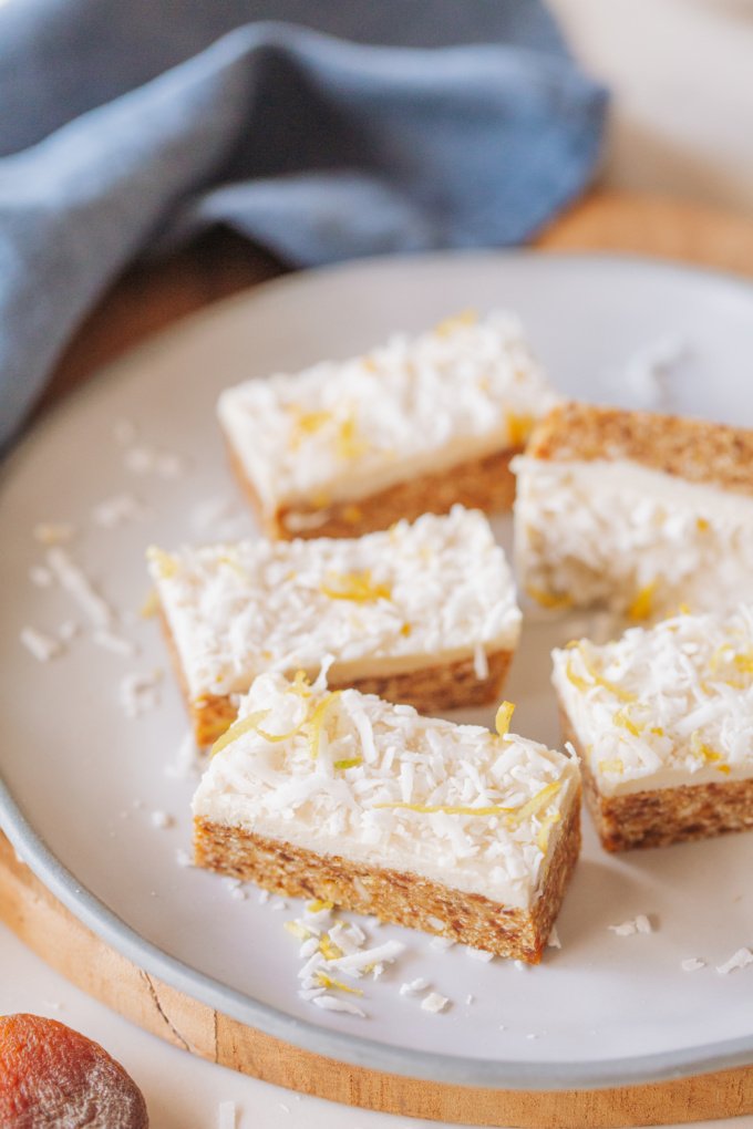 Blue plate with lemon apricot slice topped with lemon zest and shredded coconut