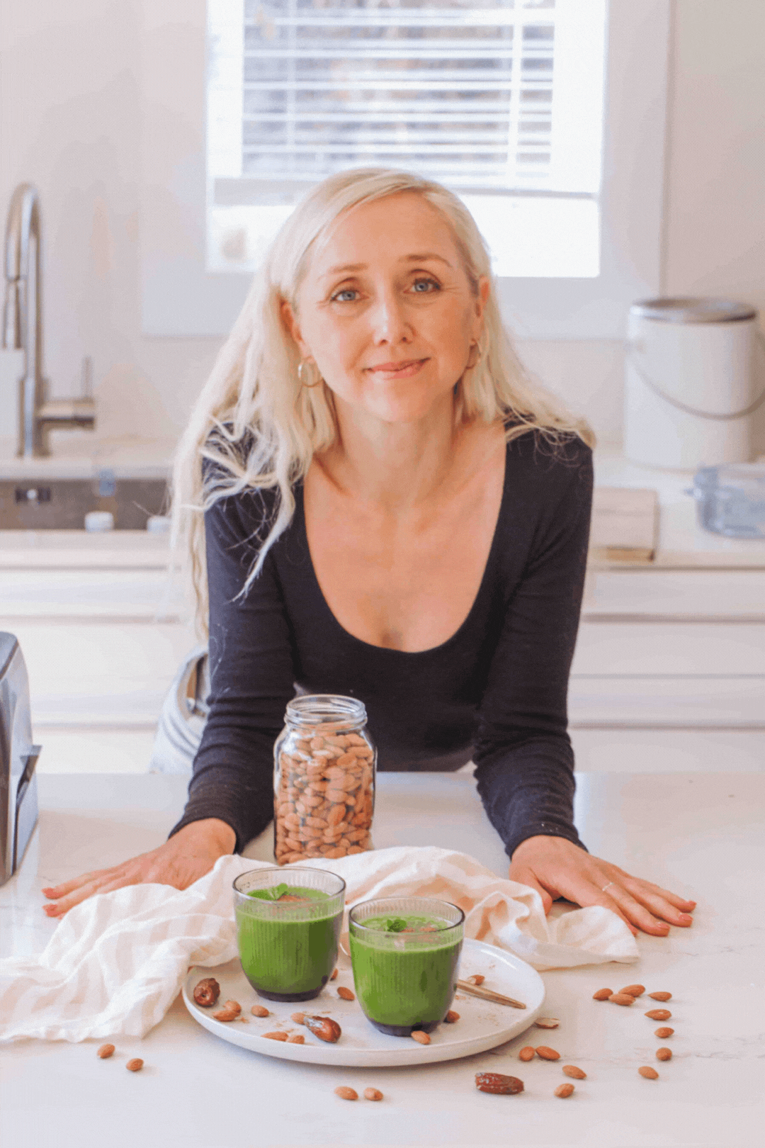 gif of buffy ellen drinking  green juice on white plate with dates, almonds, mint, and cinnamon